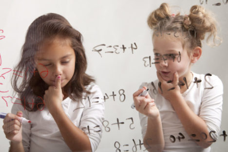 Two girls are making their mathematic assignment
