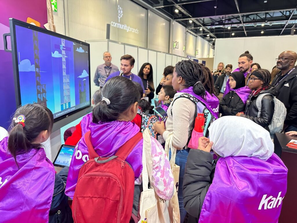 Educators engaging in a live kahoot at an expo hall booth