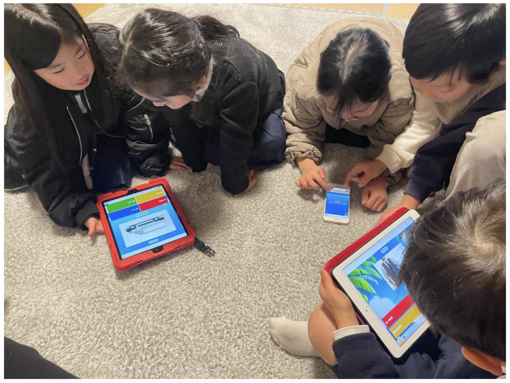 Kids sitting on circle with Ipads, playing a kahoot