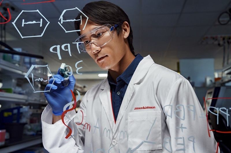 Scientist writing on glass