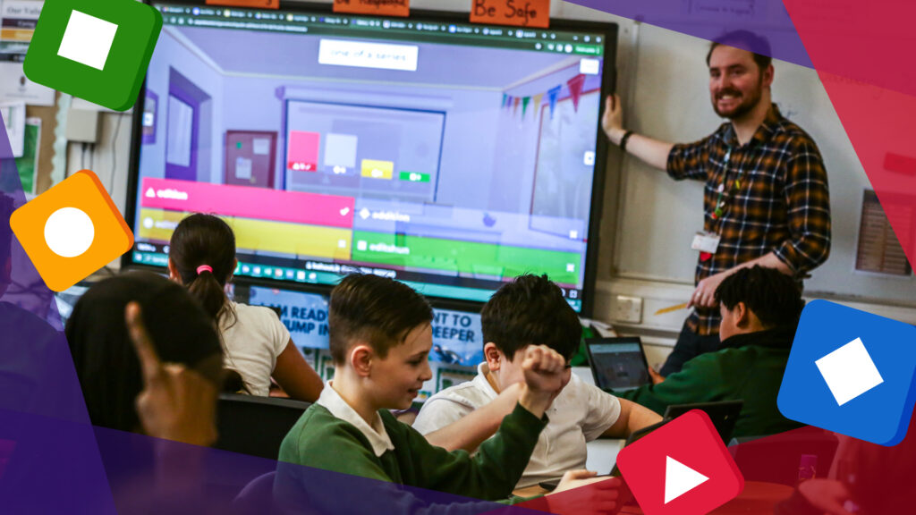  A male teacher hosting a kahoot on a large screen while teaching children, promoting interactive learning and teamwork.