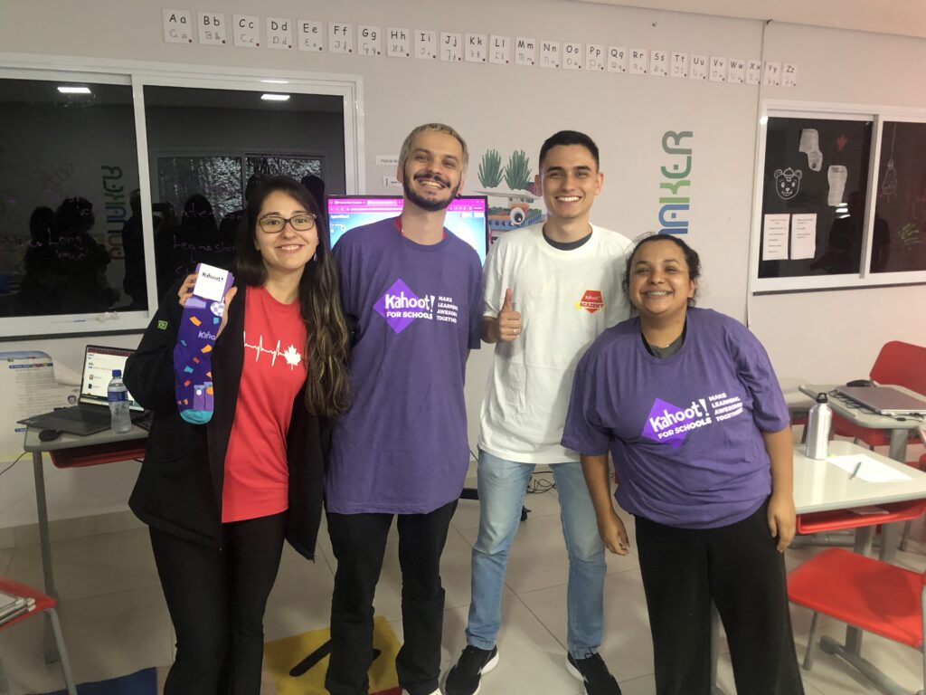 four students posing with Kahoot! t-shirts and Kahoot! branded socks