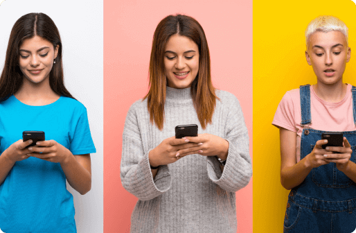 Three female students using phones, stood in front of a colorful background