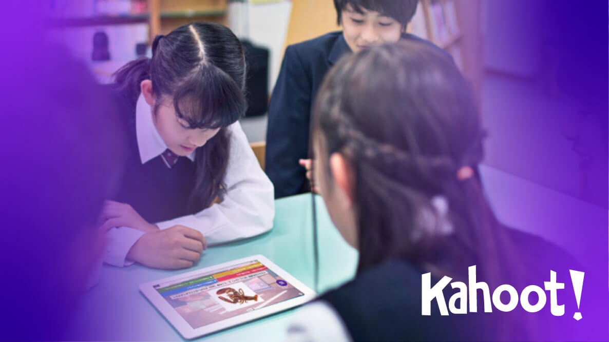 A group of students looking at an iPad that has a kahoot on the screen