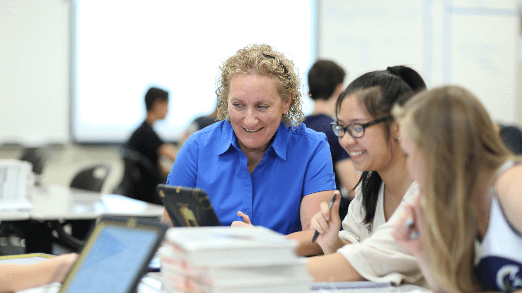 Teacher working with students in a classroom 