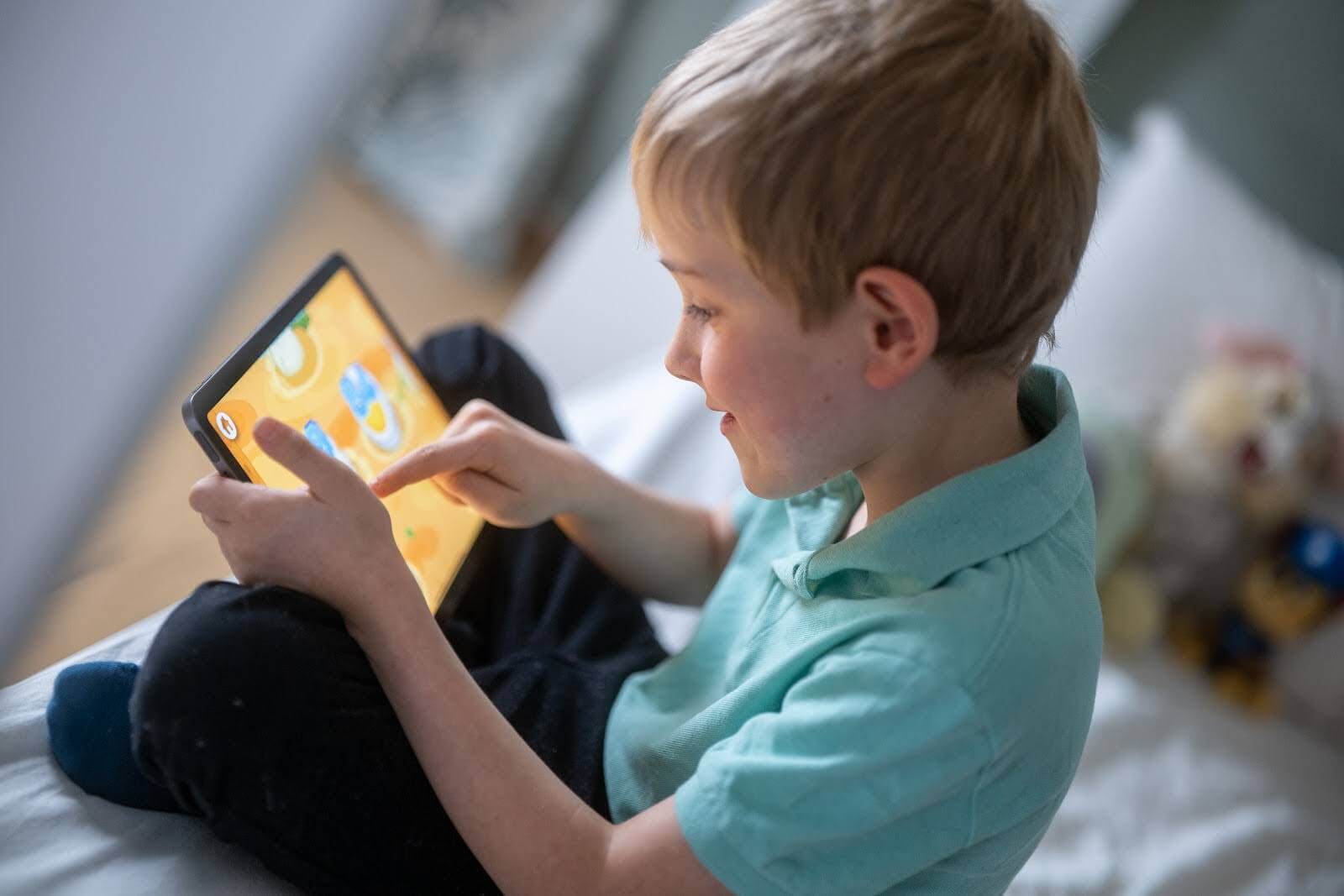 Child playing a game on a tablet device