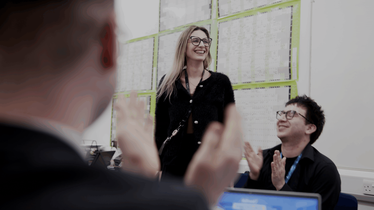 Woman with glasses doing a hair flip celebrating her Kahoot! win