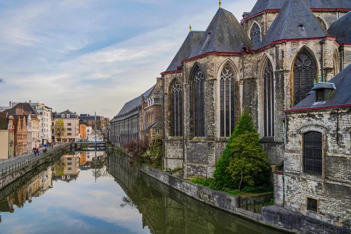 Historic medieval building on Leie riveron a summer day in Ghent, Belgium