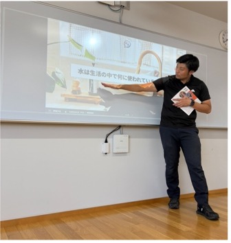 Teacher ahead of presentation board, pointing to question text