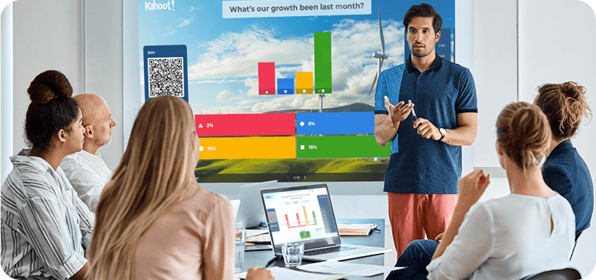 Business presentation showing a Kahoot! poll on a large screen asking about monthly growth, with a presenter speaking to a seated audience.