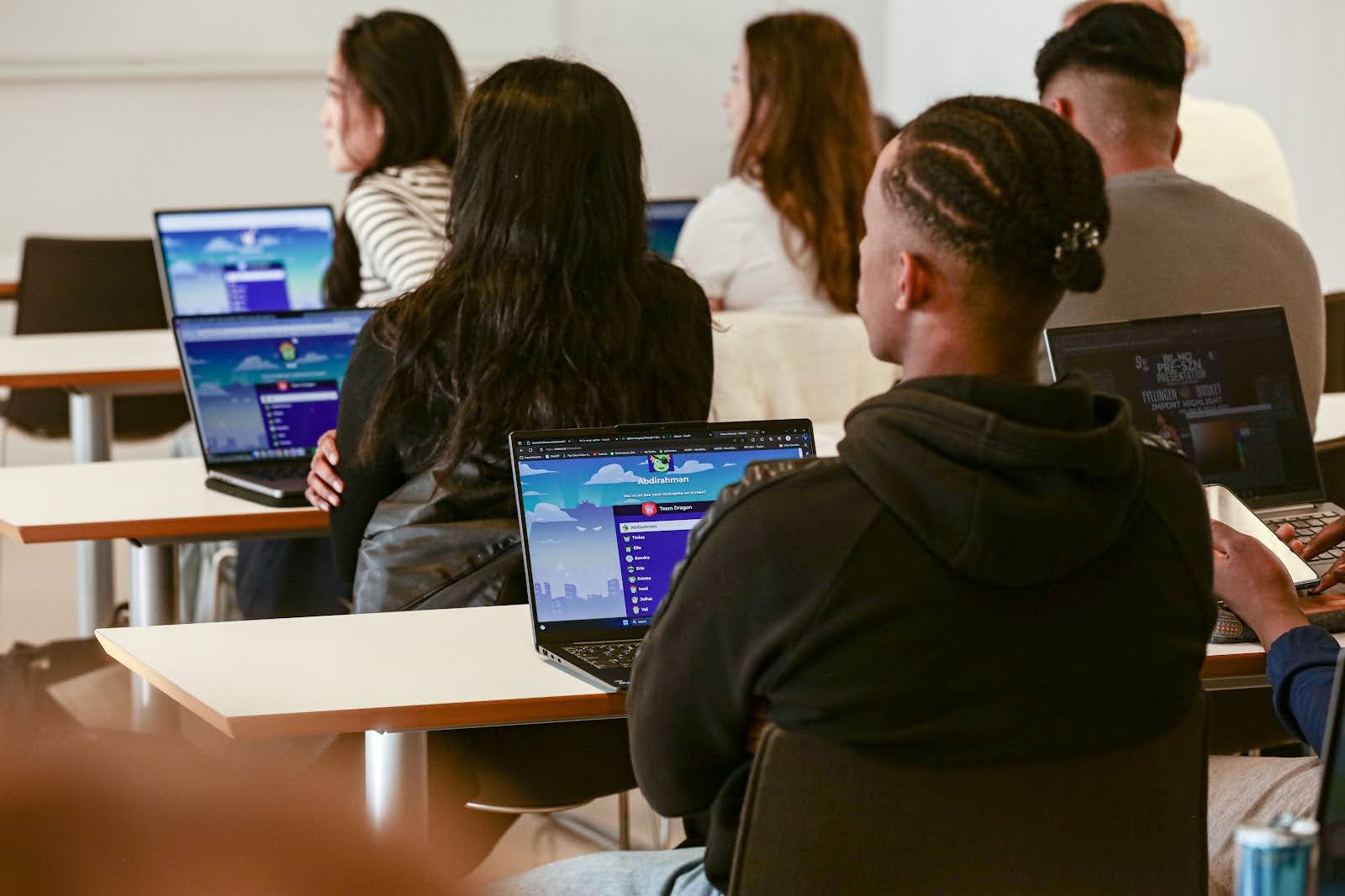 Students playing a kahoot on laptops in a classroom