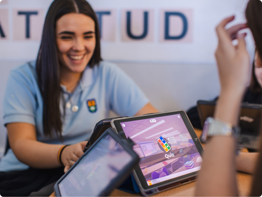 Smiling student in school uniform with a Kahoot game open on a tablet in front of her