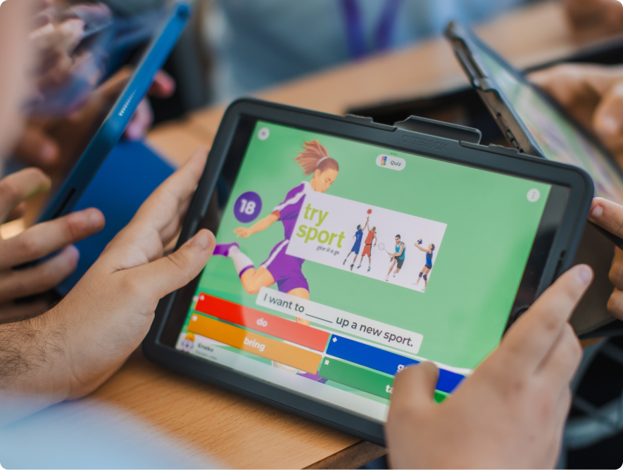 Student tapping a Kahoot fill-in-the-blank question about trying a new sport on a tablet