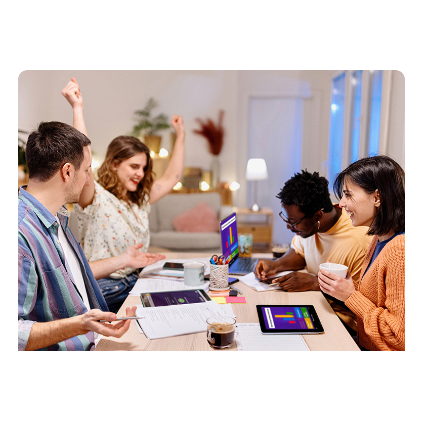 A group of people sitting at a table studying with kahoot.
