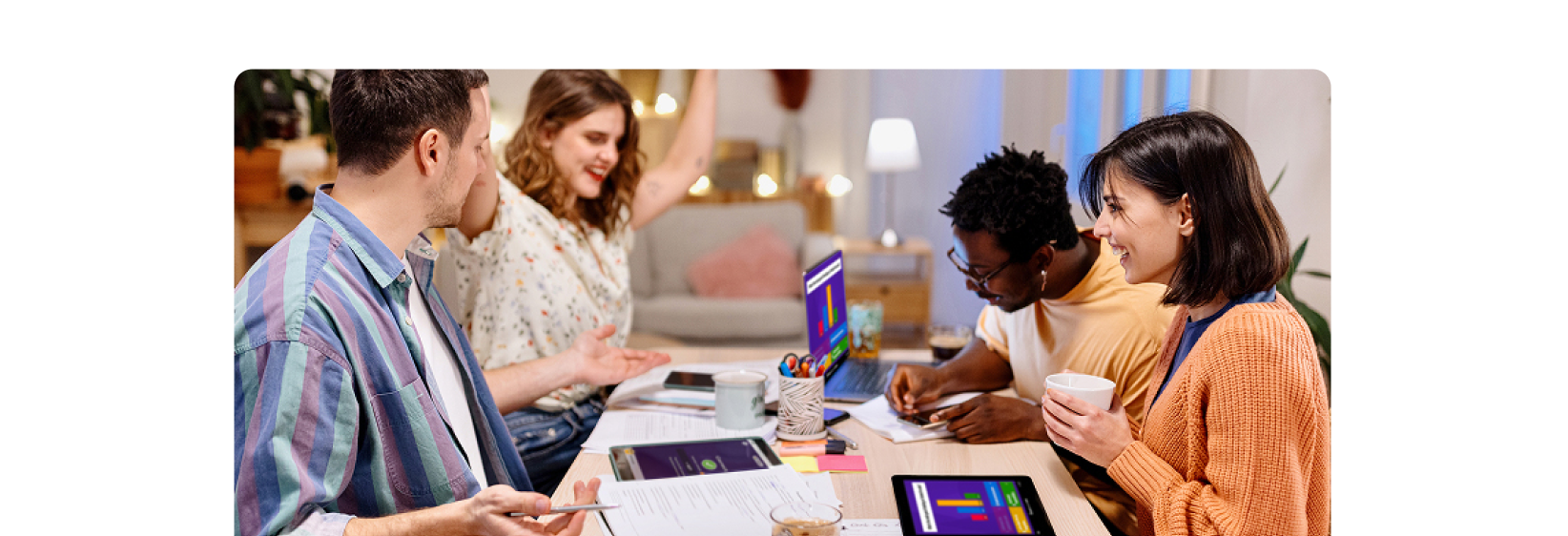 A group of people sitting at a table studying with kahoot