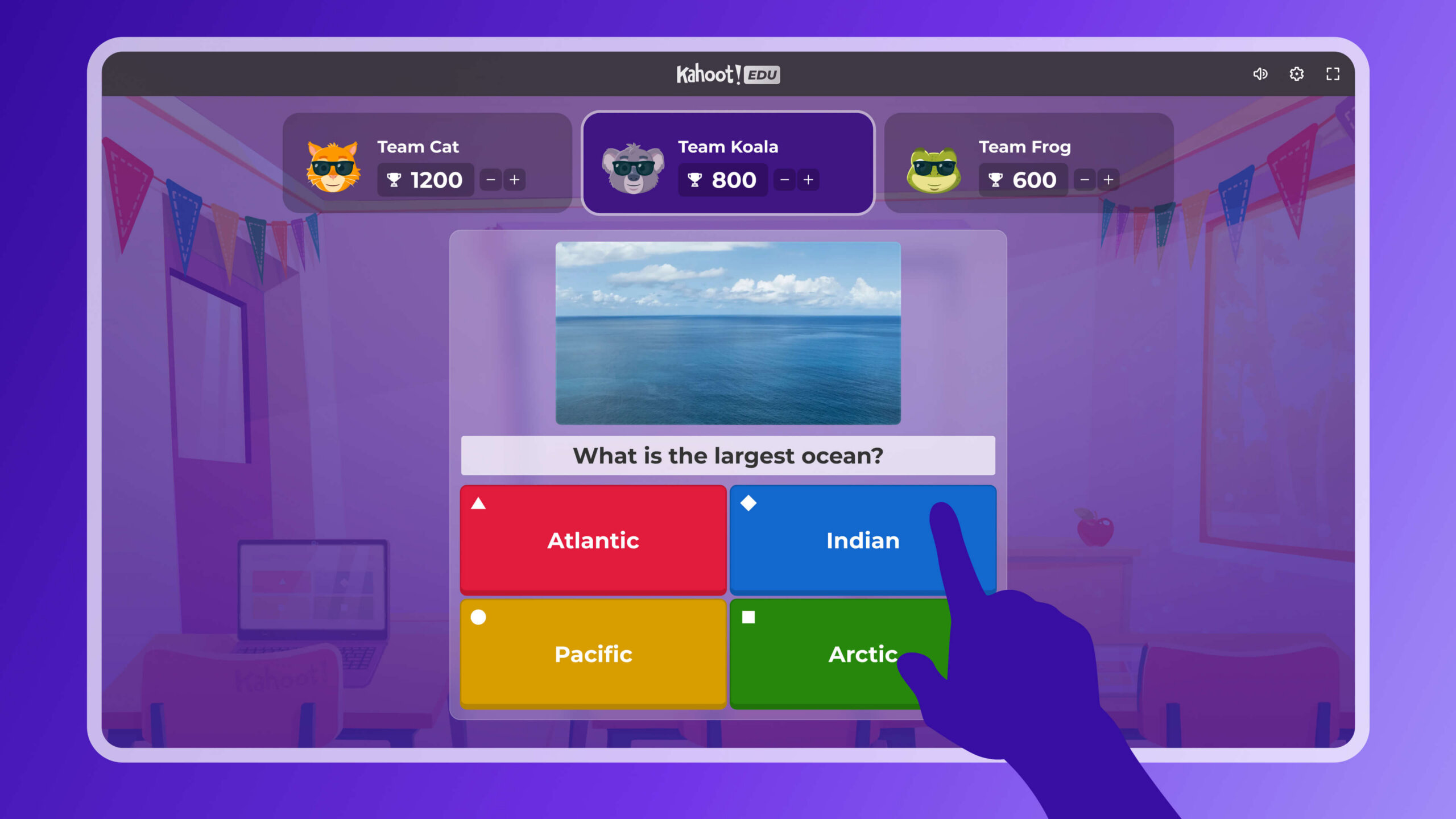 A Kahoot! EDU quiz screen displaying the question 'What is the largest ocean?' with four answer choices, and team scores for Team Cat, Team Koala, and Team Frog at the top.
