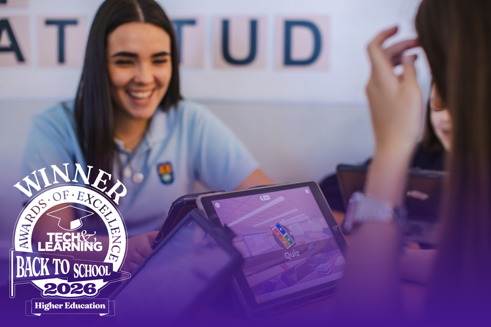 Two female students playing a kahoot session on devices in a classroom