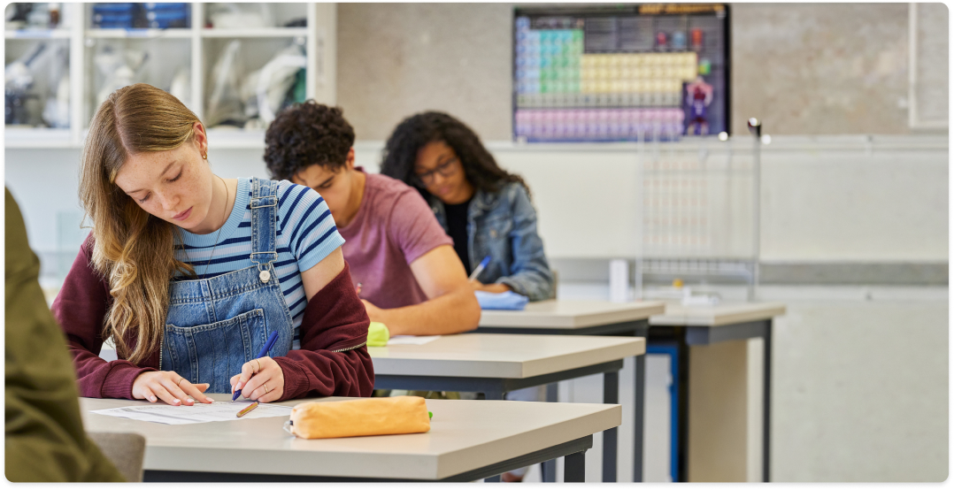 Students completing an exam in a classroom.