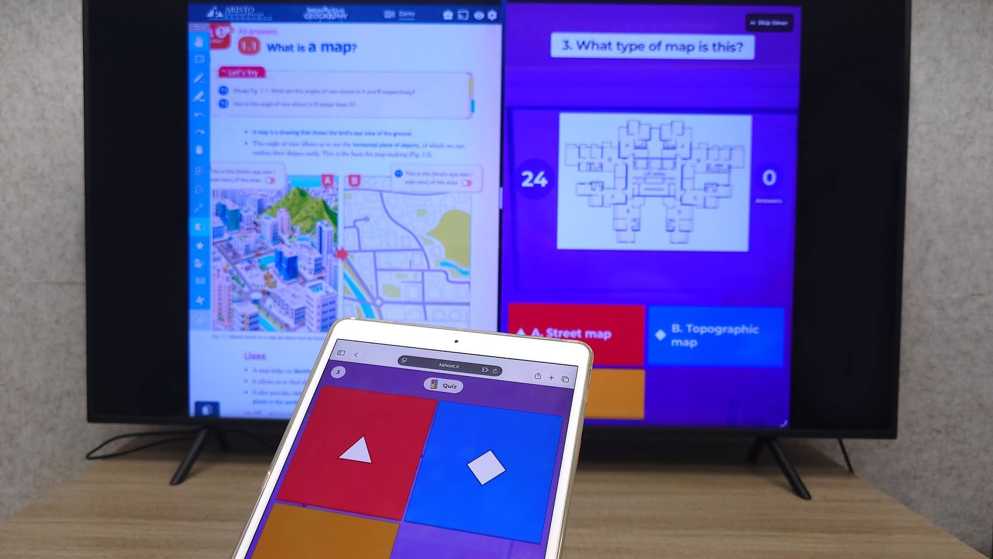 A photo of a kahoot question with answer options displayed on a smartphone and a large screen in split-screen with an Aristo digital textbook