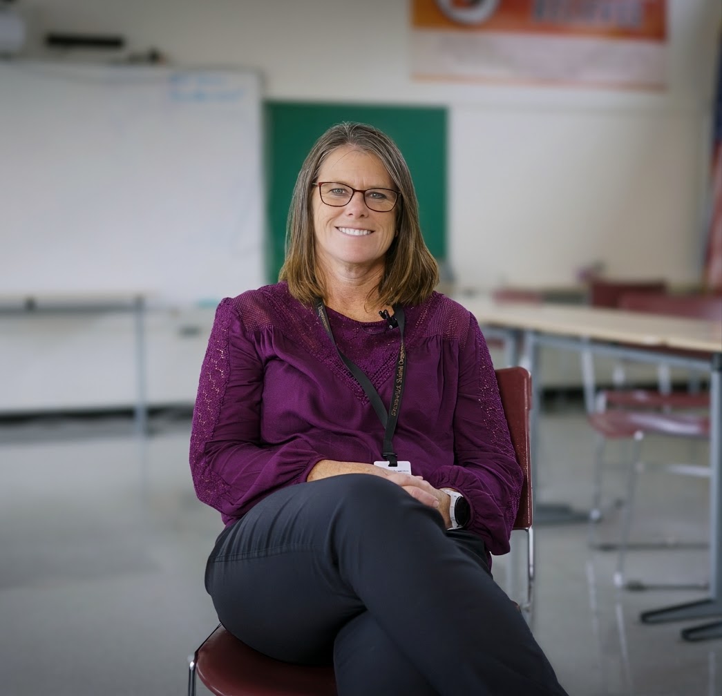 Profile picture of Tricia Faulkingham sitting in a classroom