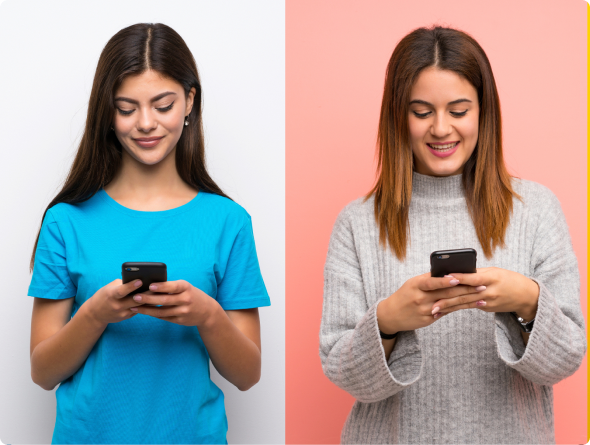 Two smiling young women look down at their smartphones against white and pink backgrounds.